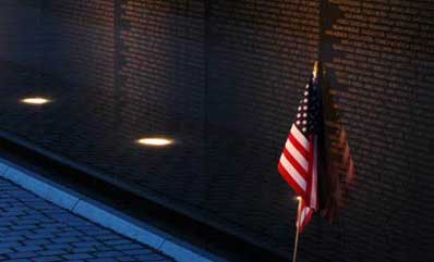 Night time photo of the wall with a flag in place Night time photo of the wall with a flag in place