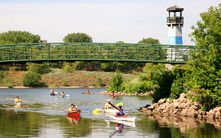 canoes and kayaks on the Mississippi River passing the Boom Island lighthouse canoes and kayaks on the Mississippi River passing the Boom Island lighthouse