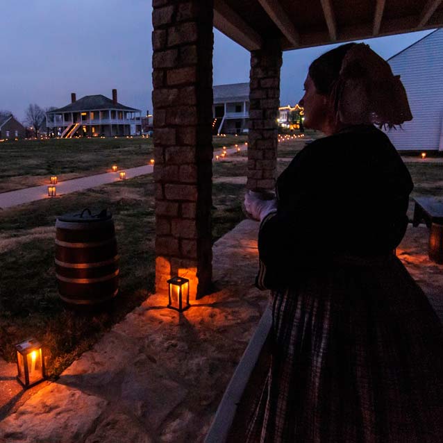Lady looking out over a scene illuminated by candle lanterns Lady looking out over a scene illuminated by candle lanterns
