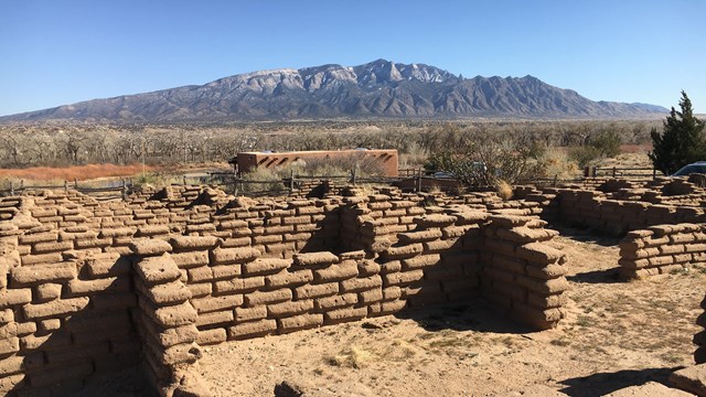 ruins of old stone walls with mountain in the back