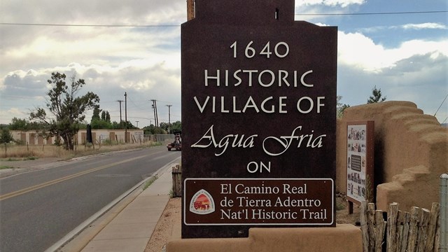 highway sign that says historic village of agua fria