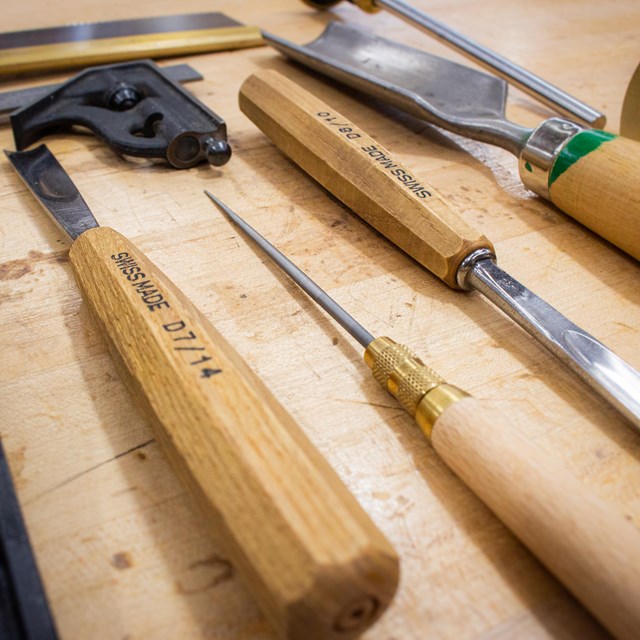 Woodworking tools on a wooden table.