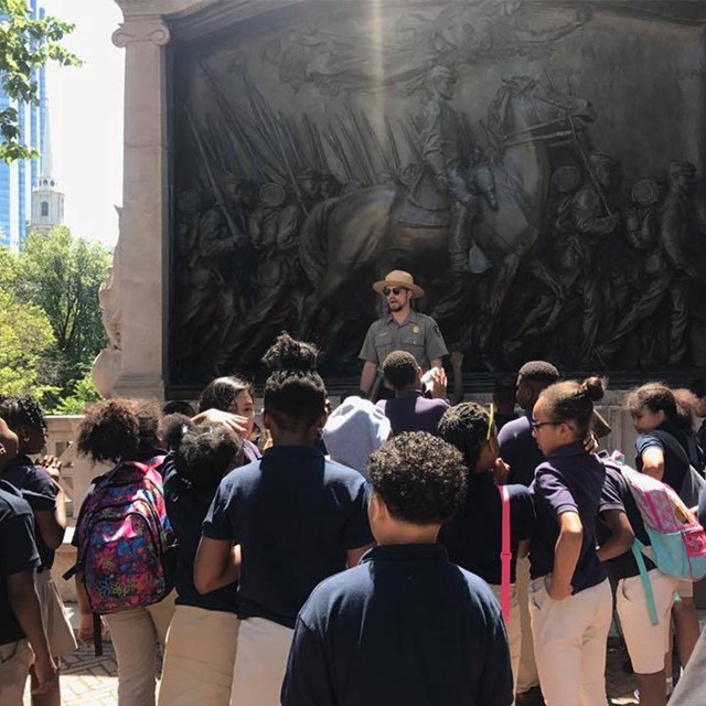 Park Ranger giving a tour to a group of students.