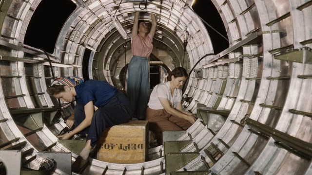 Women at the Douglas Aircraft Company working inside the tail fuselage of a B-17F Bomber.