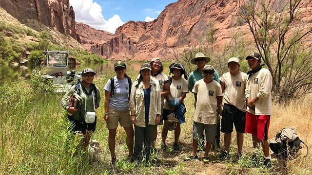 group of volunteers standing in steep canyon area