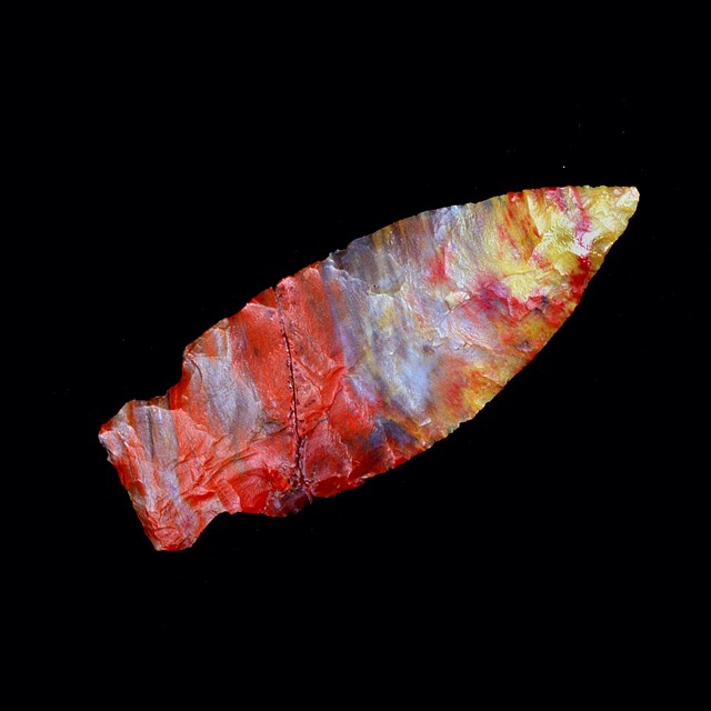 colorful arrowhead rock on black background
