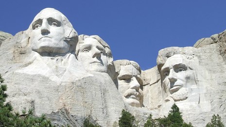 Front view of Mount Rushmore with blue skies