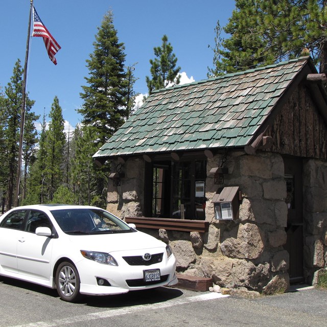 Car at entrance station in forested park