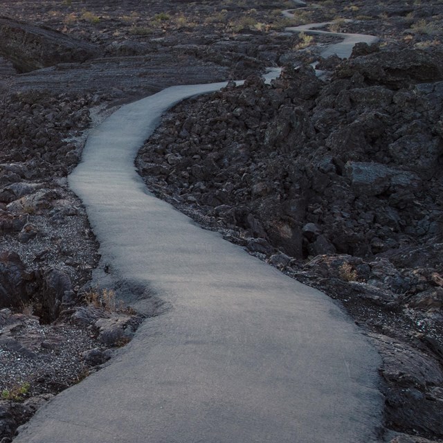 winding asphalt road through lava rocks
