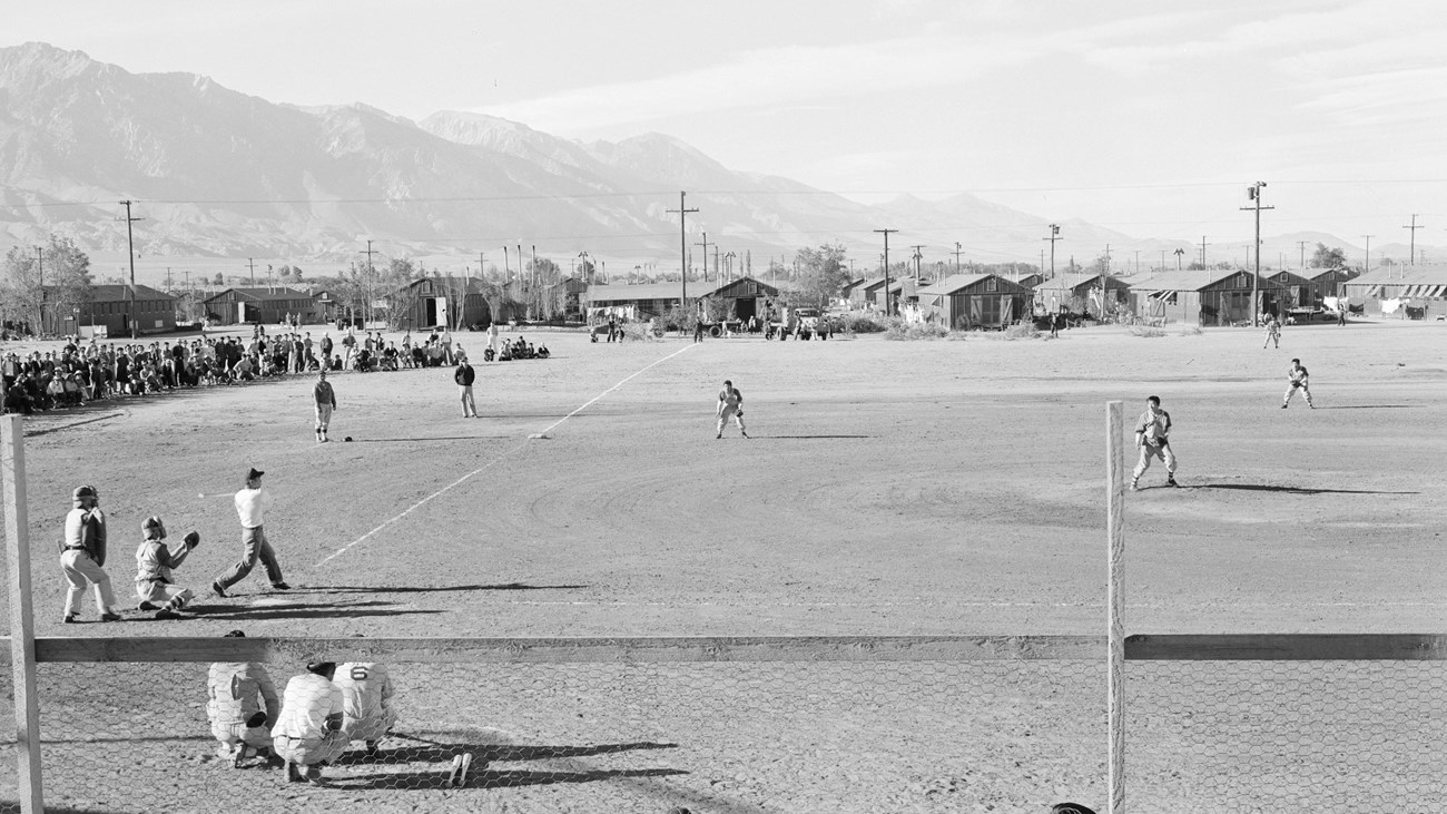 Black and white photo of a baseball game viewed from the bleachers.