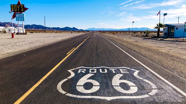 Route 66 emblem on a two lane highway