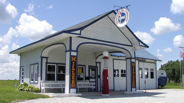 Historic gas station, white, small building.
