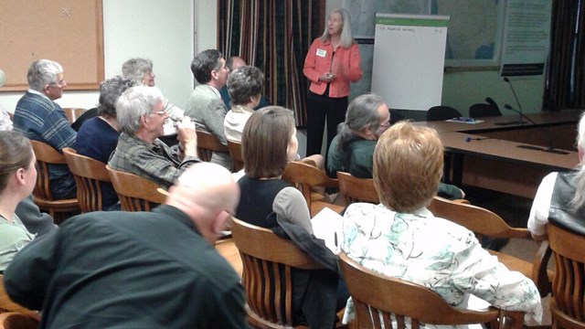 speaker standing with participants seated