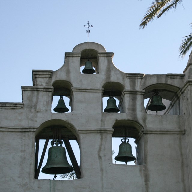 A white stucco mission bell tower. 