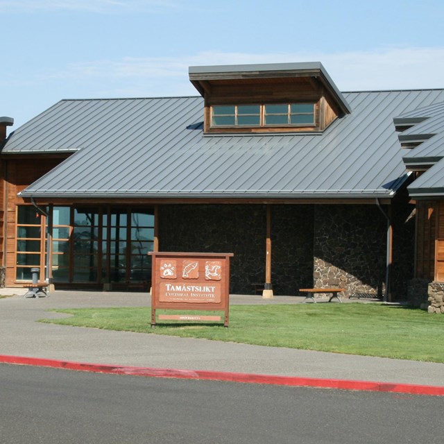 A single story building with a large slanted roof.
