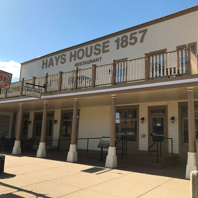 A historical two story wood, white building. 
