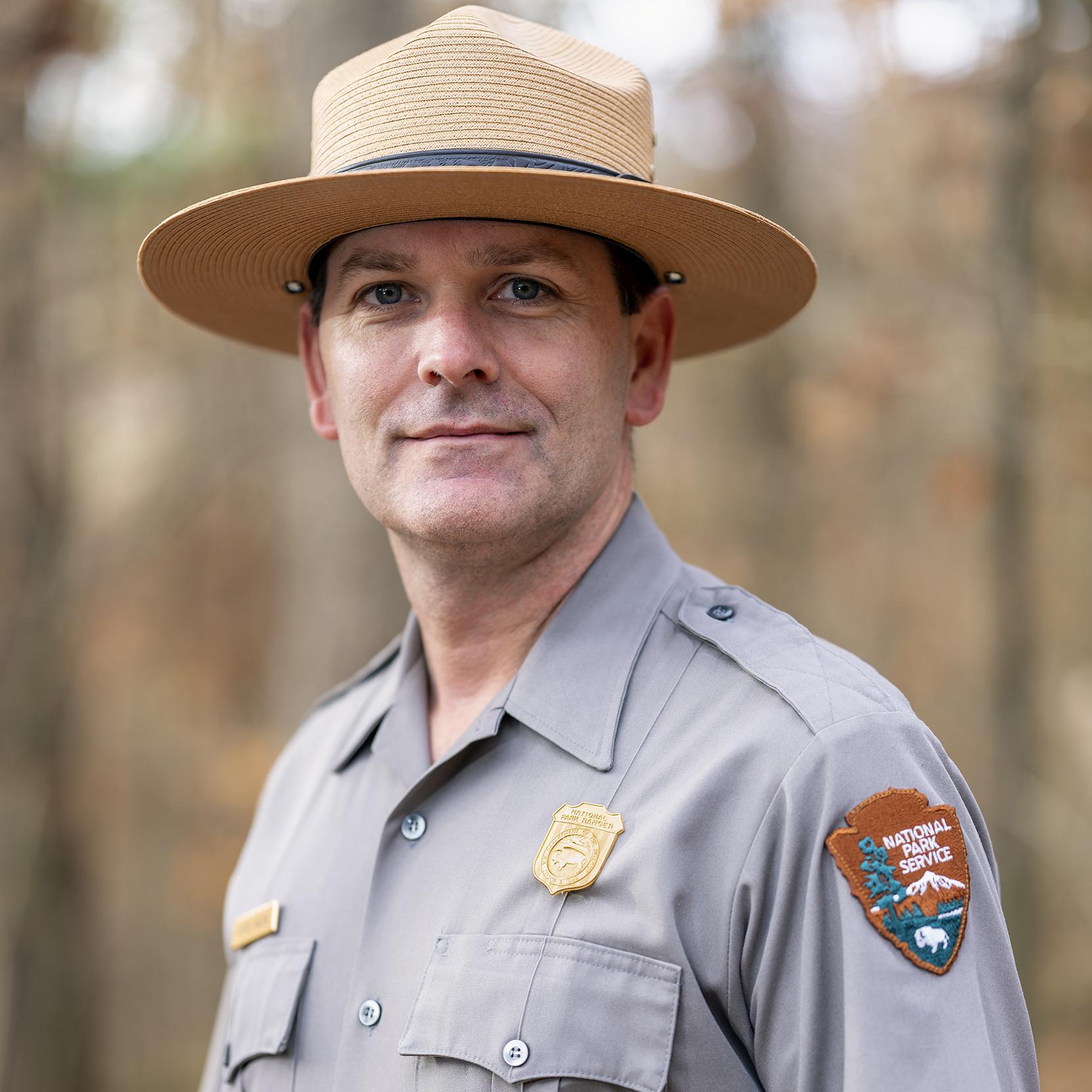 A man with park ranger uniform and hat.