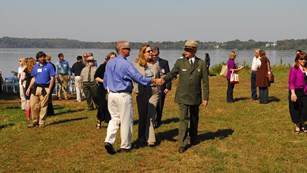 An NPS official shakes hands with a man.