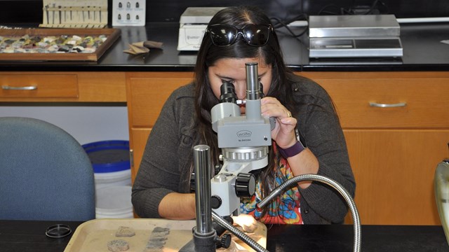 Archeologist conserving metal artifact