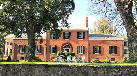view of entrance to Oak Hill with trees in front