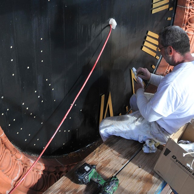 Image of clock numerals being installed on the Warwick Town Hall