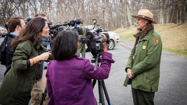 Ranger stands in front of several media crews.