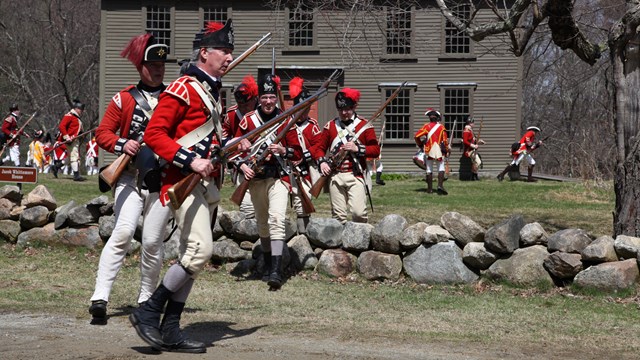 British soldiers from the Revolution search the area.