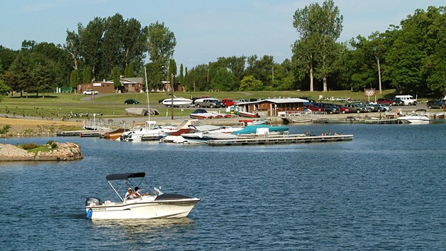 Boats near a beach with people recreating