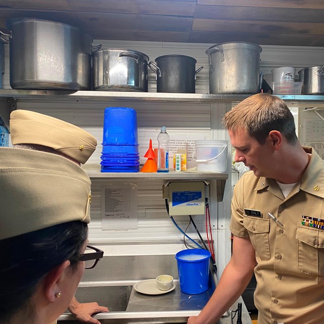 public health service officers inspect a kitchen in a park