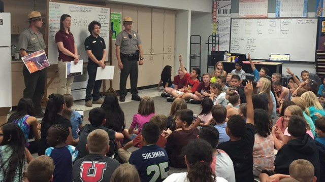 Rangers stand in front of a classroom of students