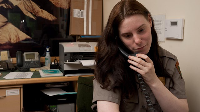 woman in ranger uniform speaking on a phone