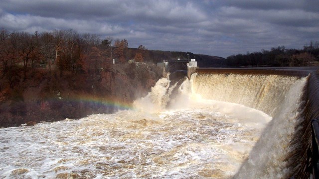 Water crashes over the dam, making a bigger water fall than normal during spring floods
