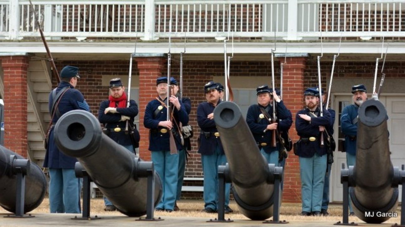 a line of men in Civil War Union uniforms with rifles 