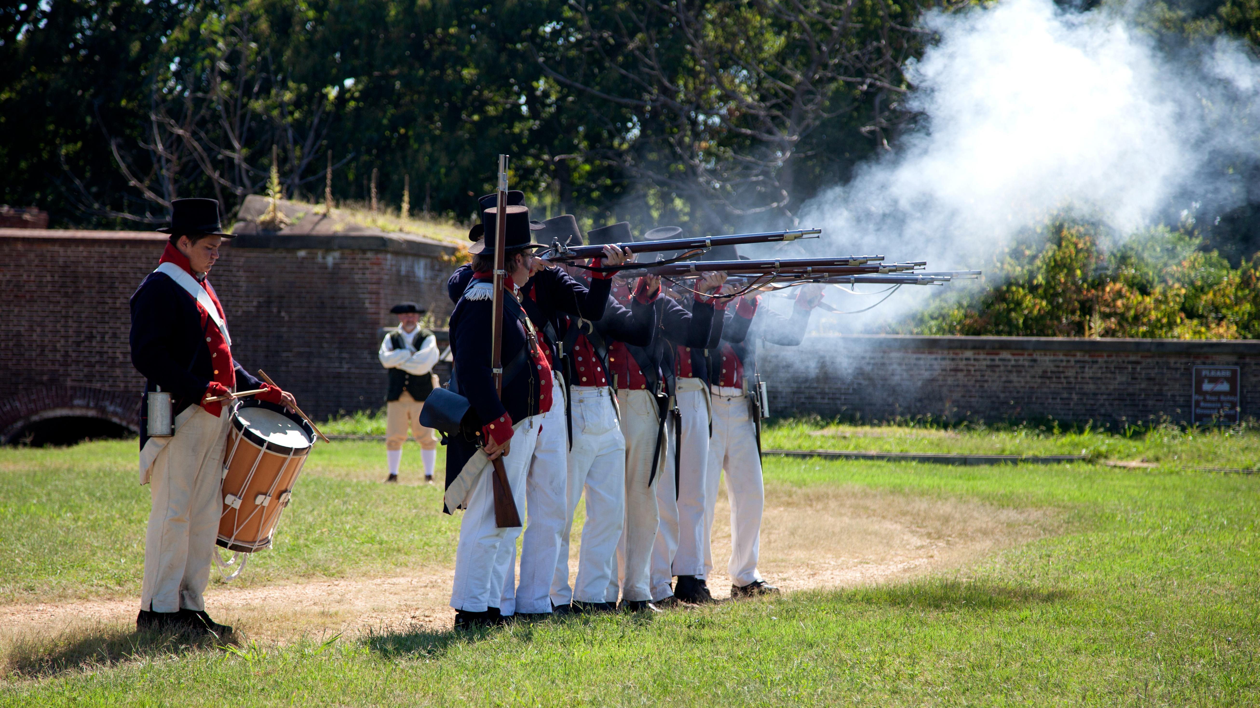 Men in War of 1812 Uniforms fire guns