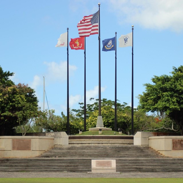 Group of flags over a memorial 