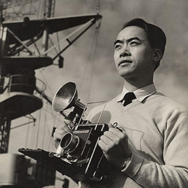 Louis Lee holding a camera. NPS photo. 