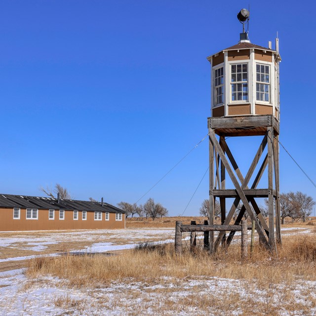 Guard tower near a long barracks building 