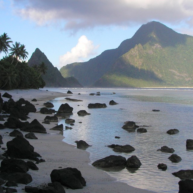 Ofu Lagoon with water and beach with mountains in background. NPS photo. 