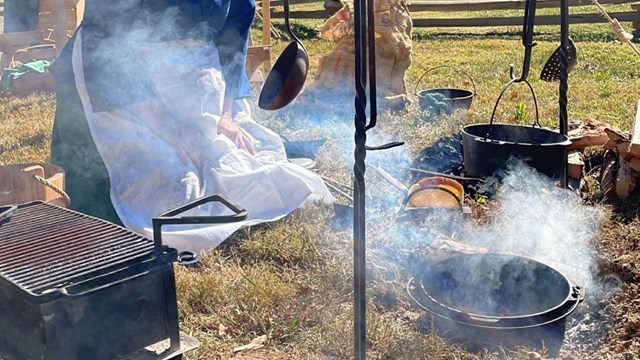 woman cooking over fire