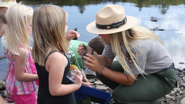 park ranger teaching small children outside