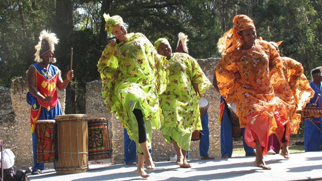 traditional dancers in colorful attire on stage