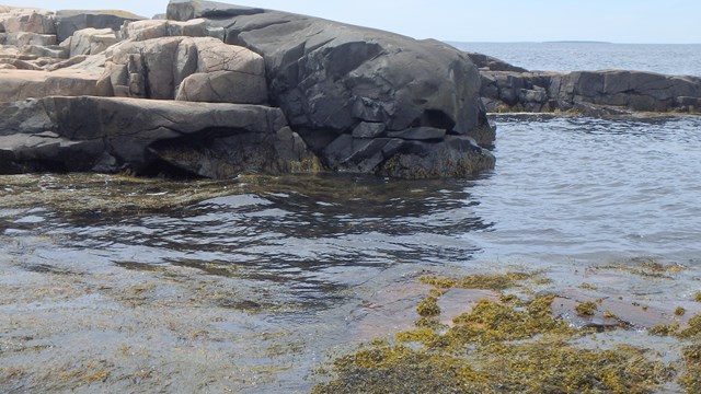 a rocky cove filled with ocean water