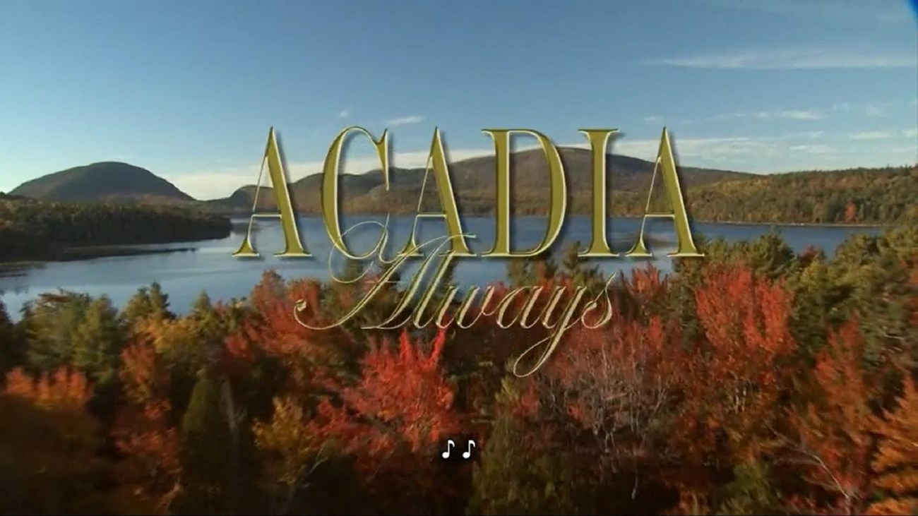 A view of a lake with mountains and trees, with text reading "Acadia Always" and a music note