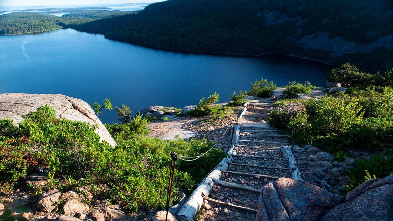 Trail leads up a mountain overlooking a pond