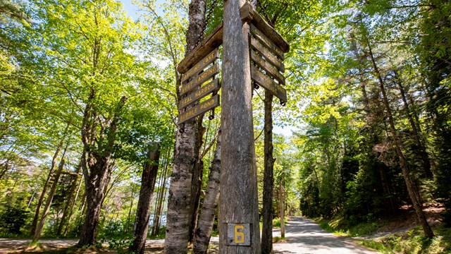 Wooden sign post with direction for carriage roads