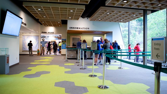 Interior view of a visitor center with people standing around