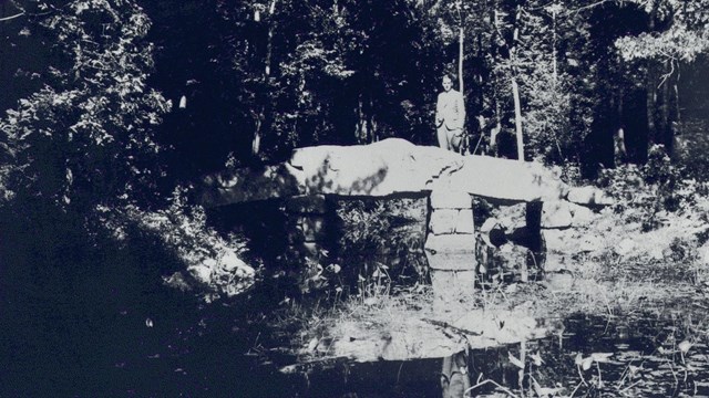 B&W Photo of man on stone bridge