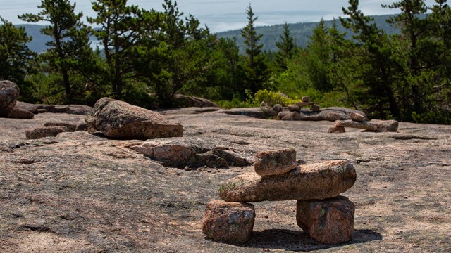 Rock cairns mark a trail on exposed rock