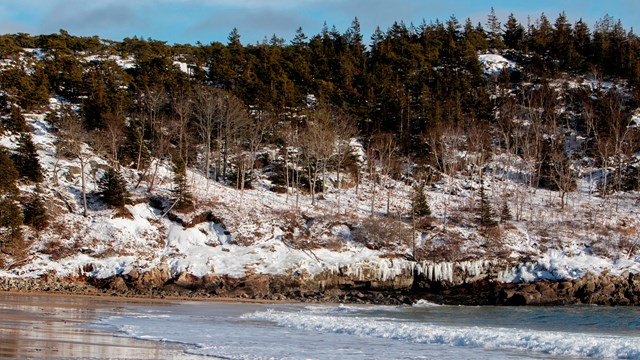 Snow and ice on cliffs along a beach