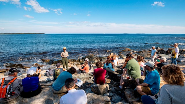 Ranger gives program to visitors on rocky coast